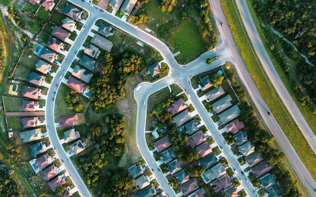 Aerial view of a suburban neighborhood with winding streets